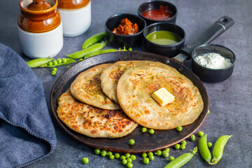 Matar paratha is a delicious Indian flatbread stuffed with spiced mashed green peas, cooked until golden and served with chutney.