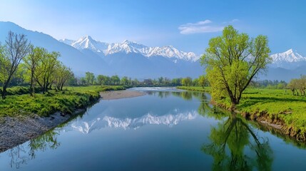 Fototapeta premium Serene river landscape with mountains and lush greenery.