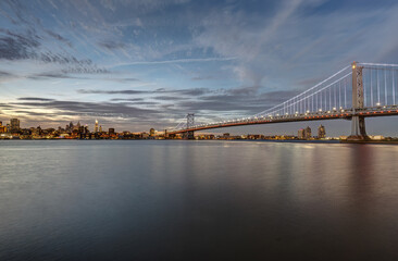 The Ben Franklin Bridge and the skyline of Philadelphia with the Delaware River at twilight