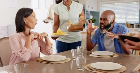 A diverse family enjoying meal together, with children passing dishes to adults