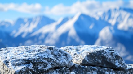 Snow dusted rocks overlook a majestic winter mountain range