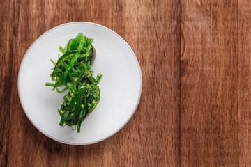 Wakame Seaweed sushi on a White Plate