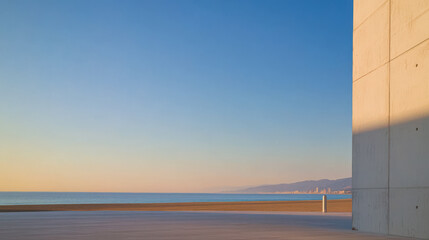 Coastal view at sunset with a clear sky and gentle waves in the background