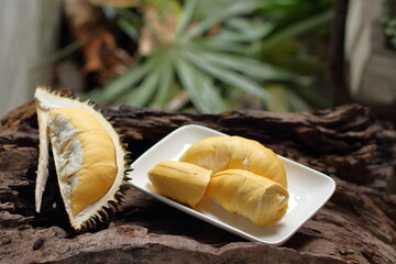 Durian in a white plate on a wooden background