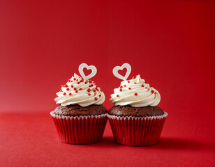 Cupcake love: Heart-themed treats on a vibrant red backdrop with copy space for your Valentines day greetings