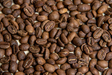 A high-quality photograph of carefully selected coffee beans, showcasing their rich texture and natural colors. Perfect for use as a background in designs, advertisements for coffee shops, cafes, or o