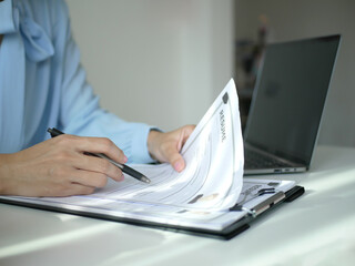 Business woman employer holds resume of job applicant To analyze data before job interviews. Regarding personnel recruitment