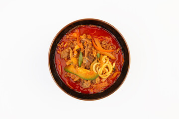 Spicy ramen, vegetables, and meat on the table