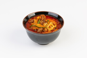 Spicy ramen, vegetables, and meat on the table
