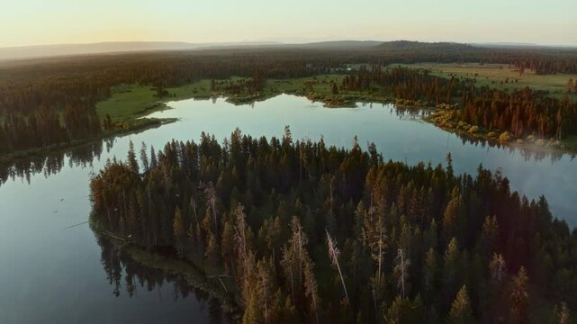 4K Drone footage of birds flying at sunrise over winding river of Henrys Fork Idaho river and Fish Pond lake