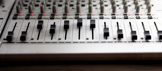 Knobs and switches of audio mixer or recording console. Recording background.  shallow depth of...