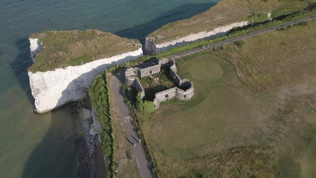 Botany Bay coastline. High aerial drone footage of castle ruins on cliffs. 2 of 14