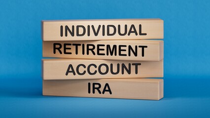 IRA - Individual Retirement Account symbol. Concept word IRA on wooden blocks.Business and IRA concept. Copy space.3D rendering on blue background.