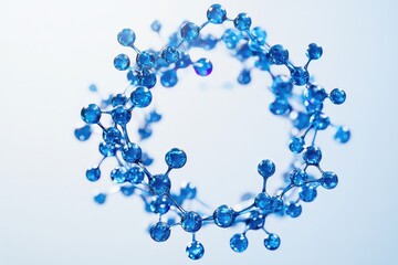 A modern, elegant circular ornament made of blue molecules and particle-like shapes for presentations or business headers.