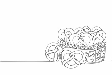 Single continuous line drawing some pretzels on wicker basket. Purchased lots for souvenir and to take home. Giving sweet food. Giving memory. National Pretzel Day. One line design vector illustration