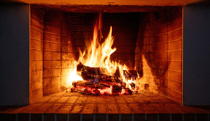 Fire burning in a fireplace, wood logs and flames. Warm home, heat. Christmas holiday