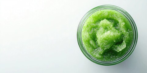 Obraz premium Homemade green body scrub in a glass jar centered on a white background with soft focus and ample space for text showcasing a SPA theme