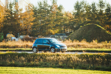 Fototapeta premium Stylish vehicle driving on countryside route