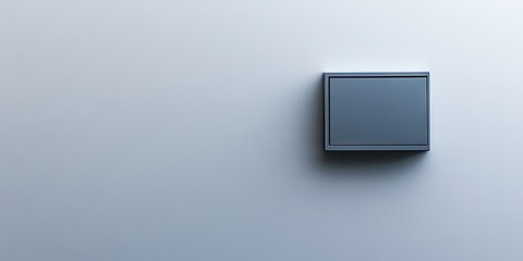 Gray electrical switch on a smooth white wall background positioned centrally with soft shadows showcasing a minimalist design aesthetic