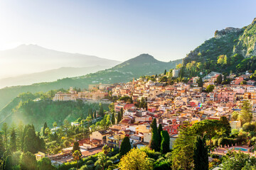 panoramic view of beautiful sunset in old european town with vintage buildings and great mountains...