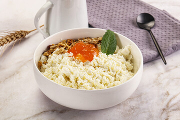 Curd with granola and orange jam