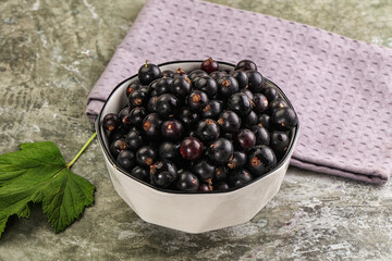 Ripe black currant in the bowl