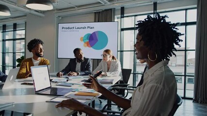 Team collaborates to finalize product launch plan during meeting in modern office space