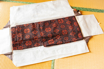 Red Japanese pattern kimono placed on tatami mats