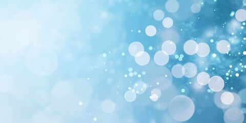 Obraz premium A blue background with many small circles. The circles are blurry and scattered, giving the impression of a dreamy, ethereal atmosphere