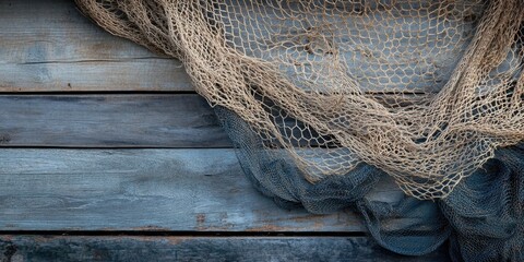 Vintage fishing nets hang gracefully on a rustic wooden wall featuring aged blue and brown tones with ample copy space for text placement.