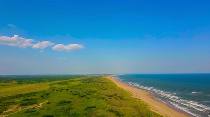 Fototapeta premium Windmills and Solar Panels Farm in Green Fields by the Ocean