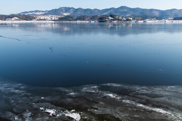 frozen river and snow-covered mountain