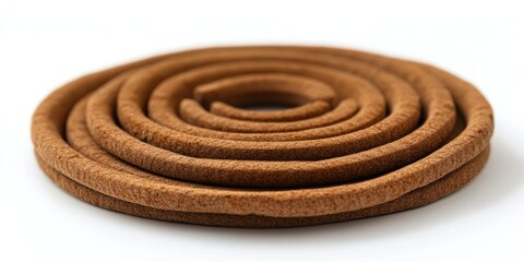 Brown circular incense coil on a white background showcasing its spiral shape and textured layers emphasizing natural materials and craftsmanship