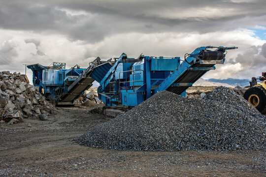 Heavy and mobile machinery in a quarry to transform stone into construction material