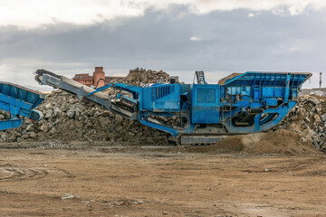 Heavy and mobile machinery in a quarry to transform stone into construction material