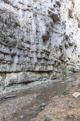 Stormy and foaming transparent waters of mountain river Adai-Su flow among sheer cliffs, stones and boulders created by nature. Kabardino-Balkaria. Chegem Nature Reserve. Autumn 2024.