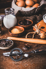 Assorted baking ingredients on wooden vintage table, brown colors