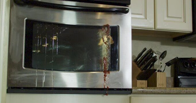 Pie splattering onto kitchen oven in epic slow motion