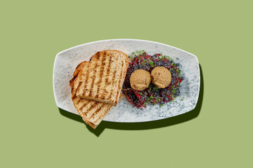 A playful and delicious take on the classic appetizer, this plate features two toasts topped with a creamy pate shaped into adorable owls