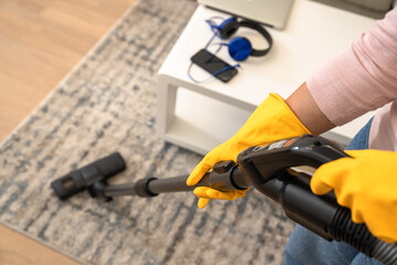 Housekeeper vacuuming the floor, cleanliness concept