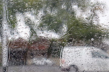 rain drops on car window in the city