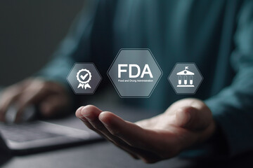 FDA Approved Food and Drug Administration concept. Businessman using laptop with FDA icon on...