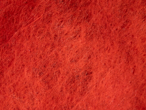 A close up of a red fabric with a fuzzy texture