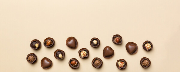Different kinds of chocolates on colored table close-up. Top View and Flat Lay with copy space