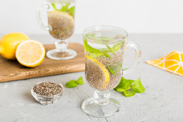 Healthy breakfast or morning with chia seeds lemon and mint on table background, vegetarian food, diet and health concept. Chia pudding with lemon and mint