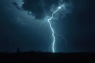 Lightning strike illuminating dark cloudy sky at night