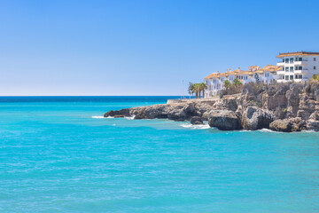 Nerja town, a resort of The Costa del Sol seaside region in Andalusia in the south of Spain. Coastal villas overlooking a turquoise sea on a sunny day.  Relaxing beach view.