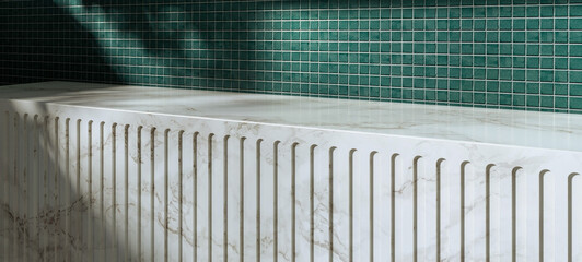 An empty marble countertop against a wall covered with deep bottle green ceramic tiles. Background for product presentations. Space for displaying cosmetics or kitchen products