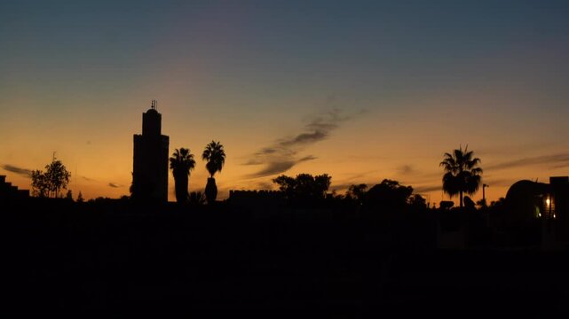 The colors of the sunset  of Marrakech with the African sun and the silhouette of the Koutoubia Mosque in Morocco Africa 