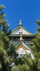 Fototapeta premium Majestic Osaka Castle A Historic Japanese Landmark with Golden Accents and Elegant Architecture